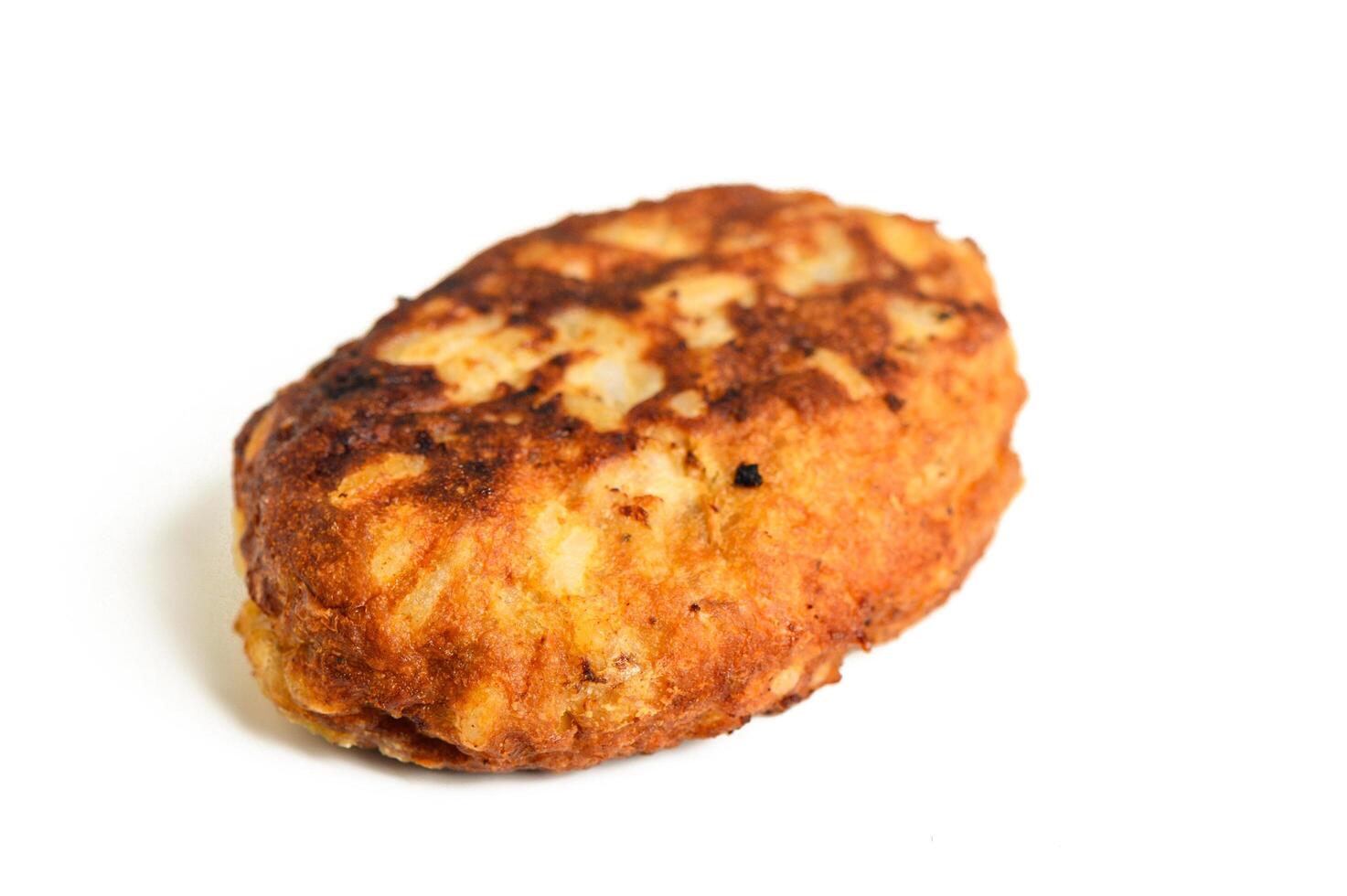 Fried cutlet in bread crumbs, isolated on the white background photo