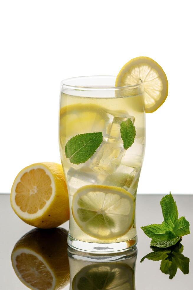 A glass of a drink with a lime slice on top photo