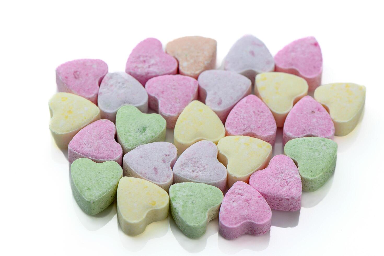 A close-up view of a pile of colorful candy hearts photo