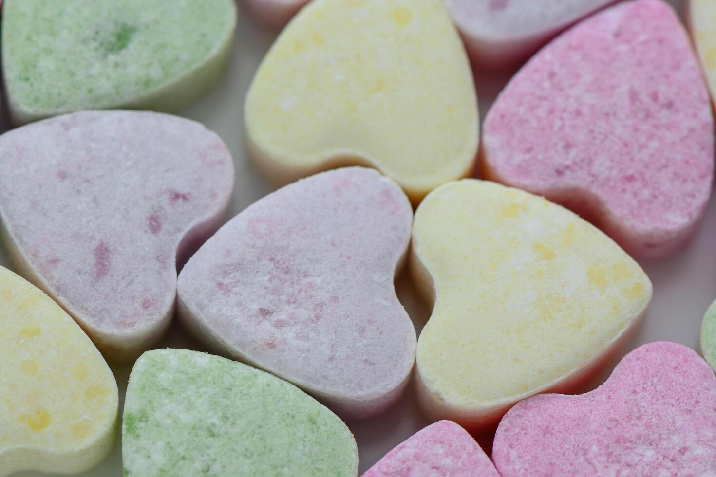A close-up view of a pile of colorful candy hearts photo