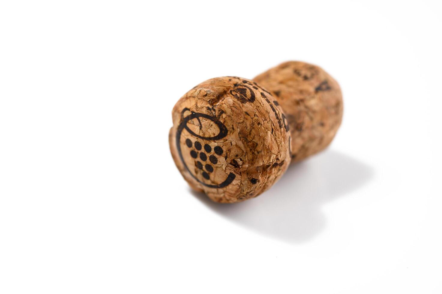 Wine bottle cork Isolated on white background. One Wooden Cork Close up. photo