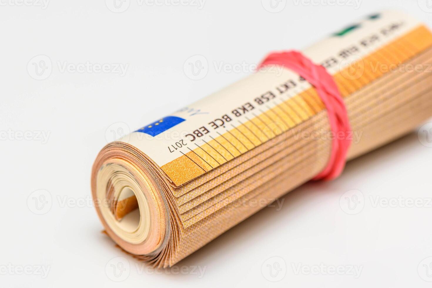 Roll of Euro bank notes, isolated on white, with a reflection underneath photo
