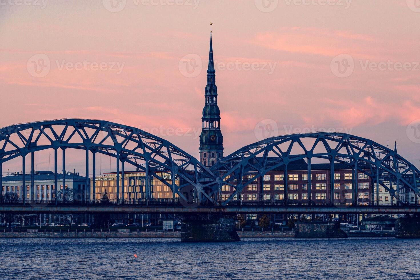 Riga embankment to the bridge on the river and clouds in summer photo