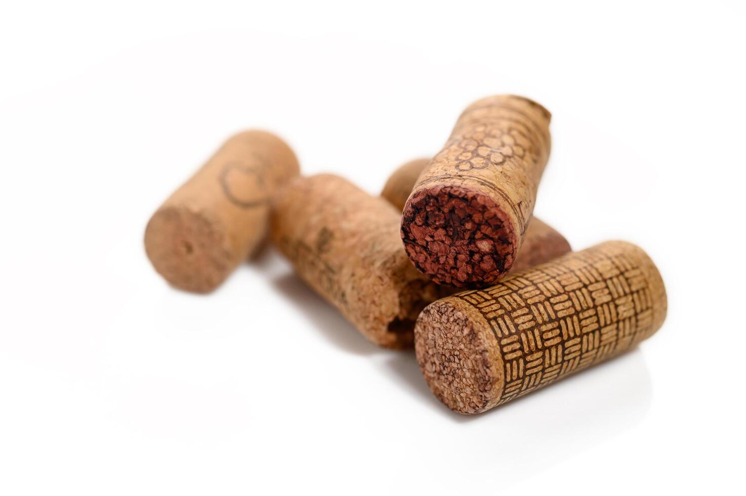 Group of natural wine corks, recycled corks isolated on a white background photo