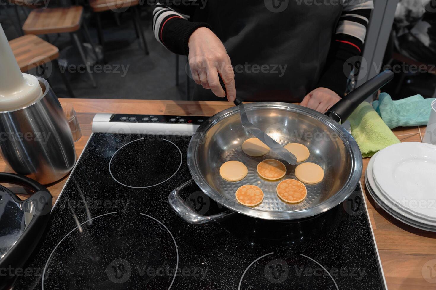 Frying mini pancake cereal in a nonstick frying pan. photo