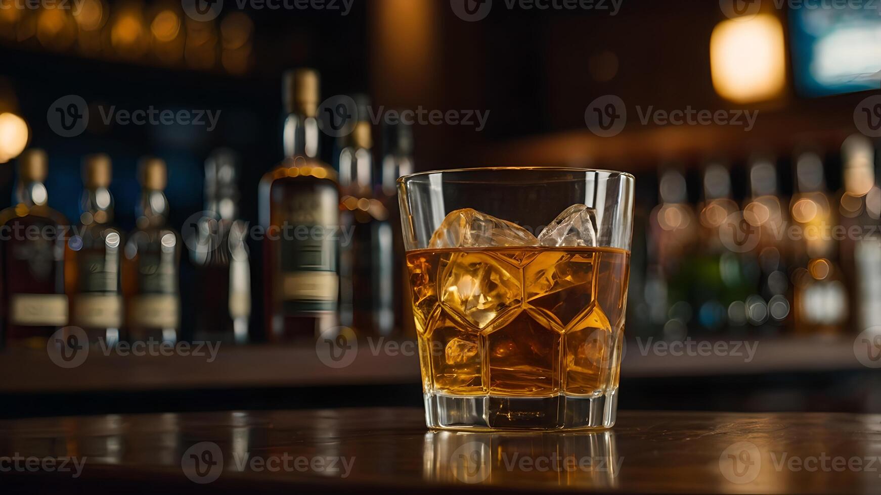Whiskey Glass on a Bar Counter with Bottles in Background photo
