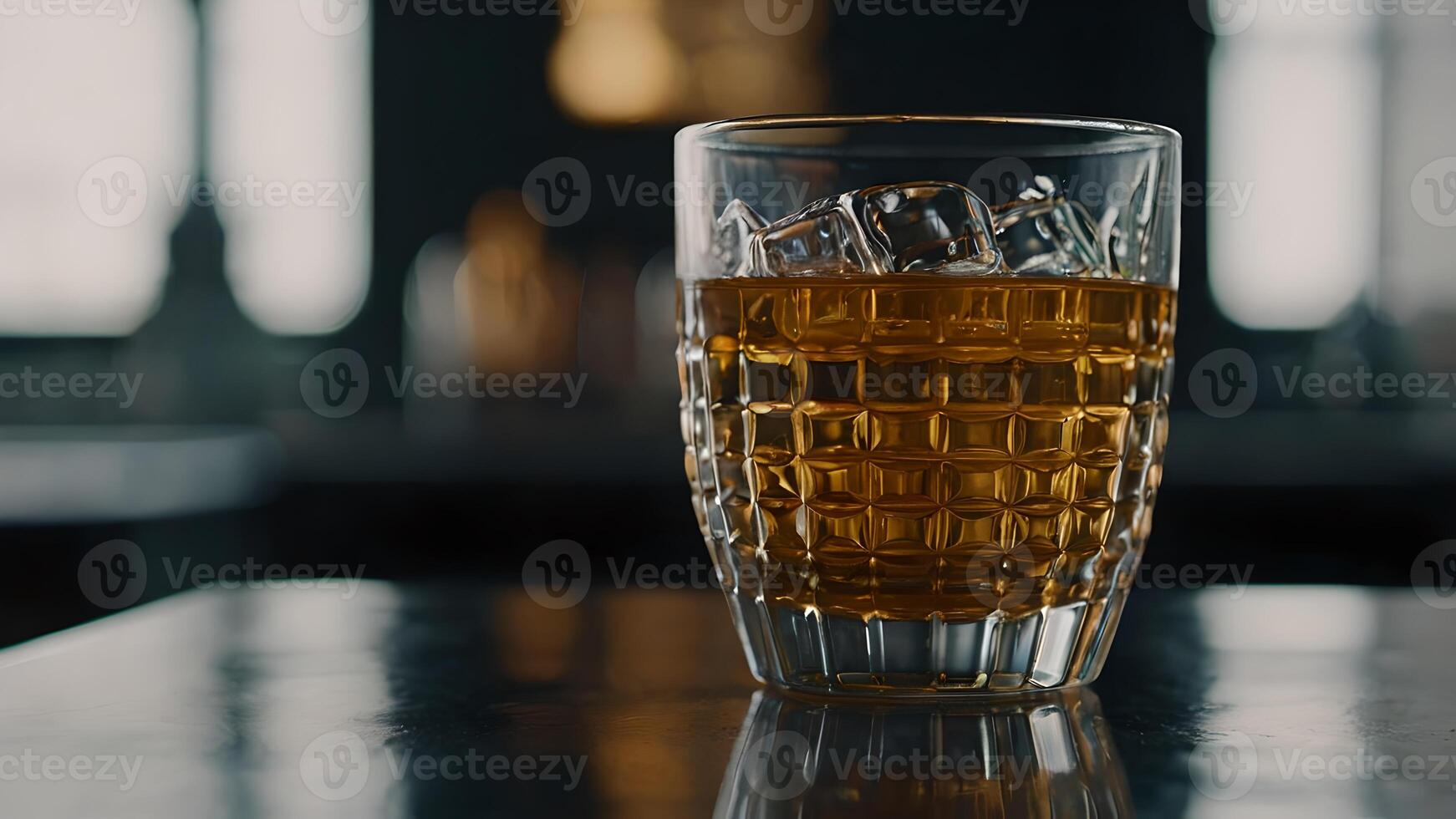 Refreshing Glass of Whiskey with Ice on a Table photo