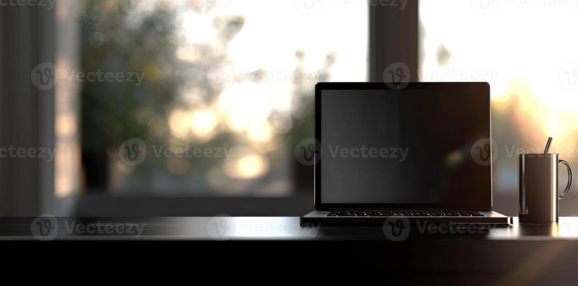 Laptop and coffee cup on black table in office. Workplace concept photo