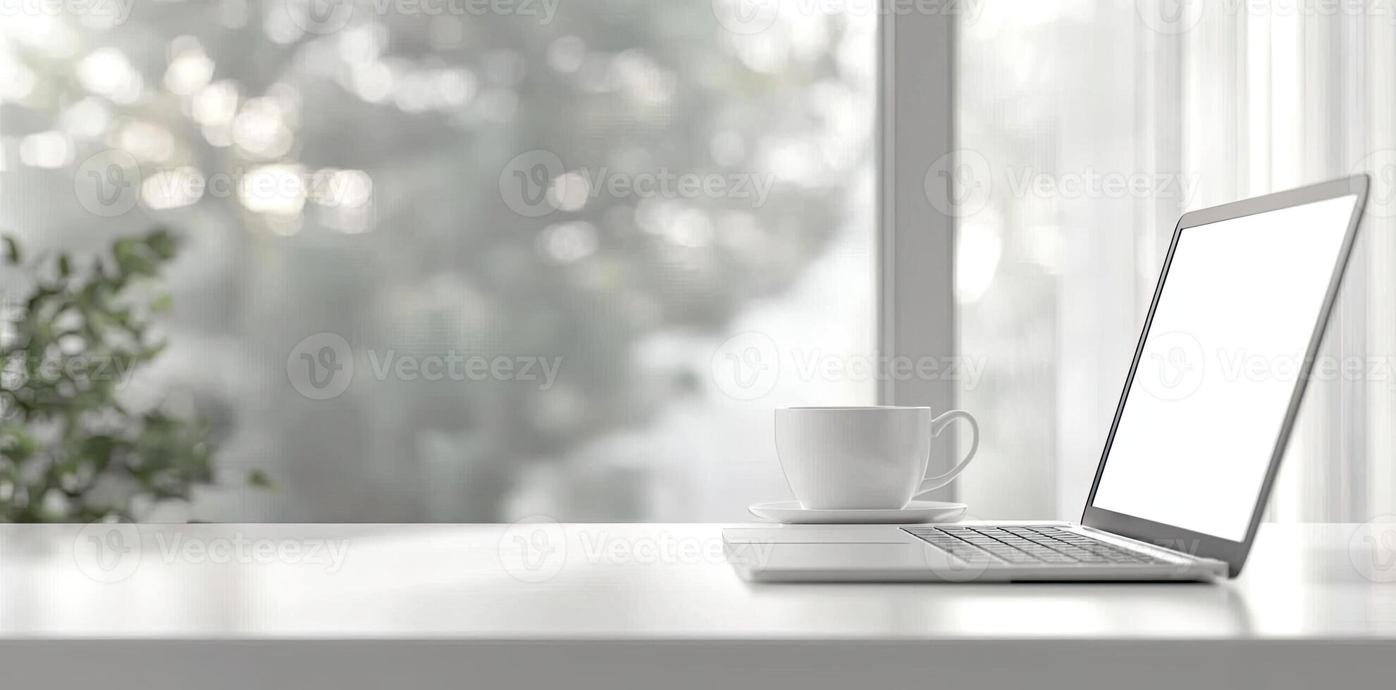Blurred background of a modern home office interior with a laptop computer and a coffee cup on a white table, with copy space for text in the blurred window view. Business work from home concep photo