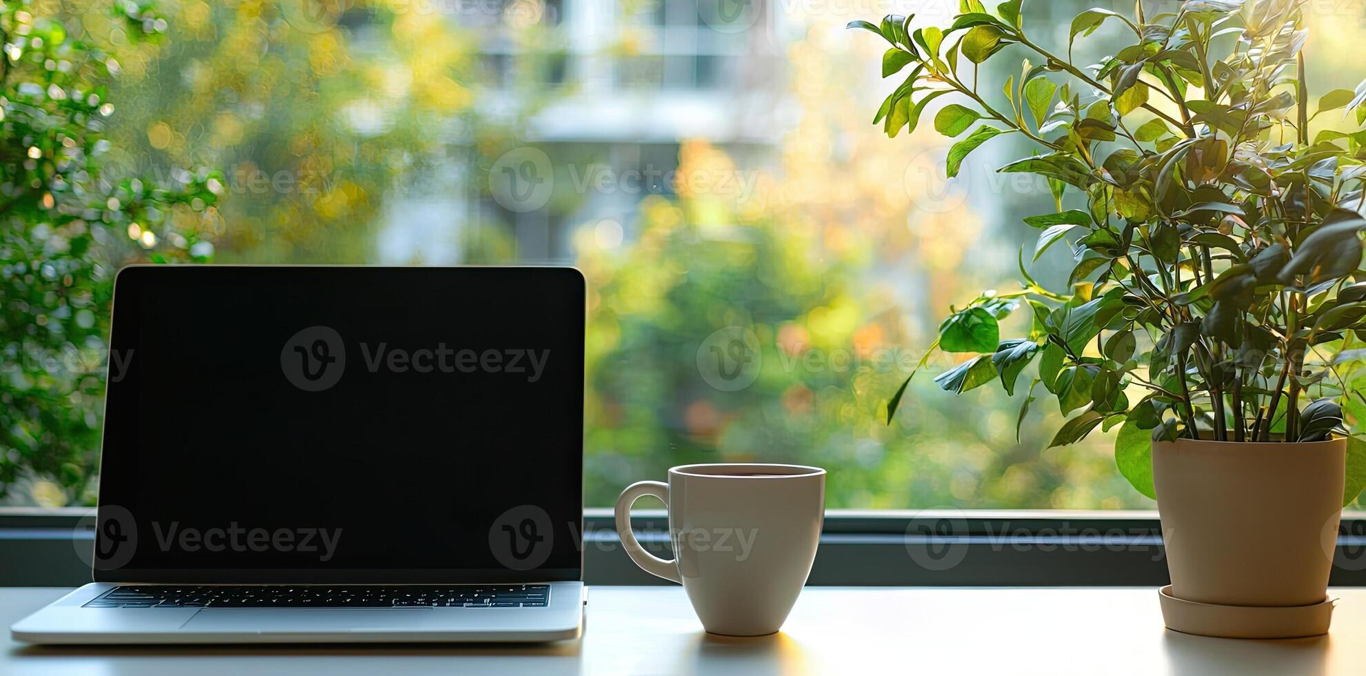 Blurred background of a modern home office interior with a laptop computer and a coffee cup on a white table, with copy space for text in the blurred window view. Business work from home concep photo