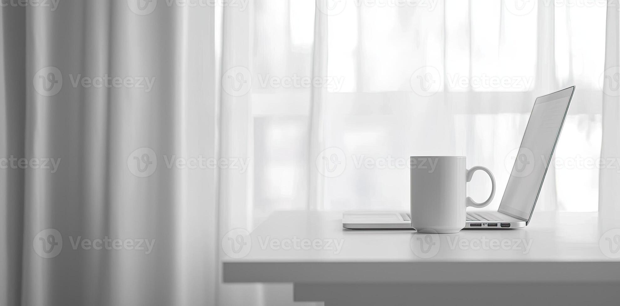 Minimalist white office desk with laptop and coffee mug on a blurred background, with space for text, representing the concept of working from home photo