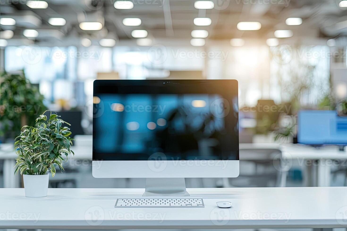 Minimalist white desk with a computer and office background, blurred business center interior in the blurred background. Mockup for design or presentation photo