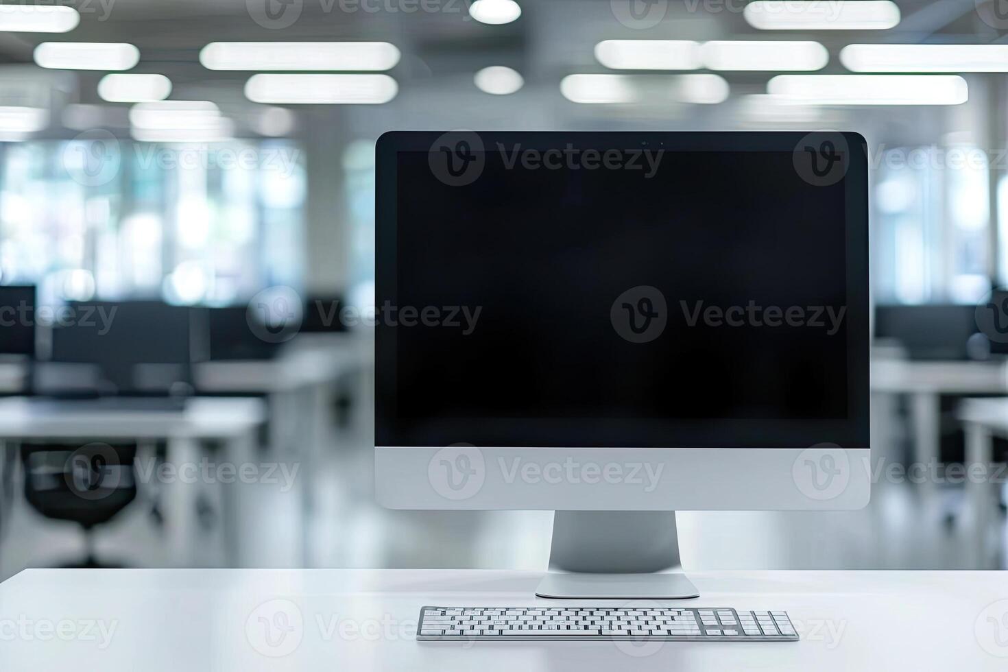 Minimalist white desk with a computer and office background, blurred business center interior in the blurred background. Mockup for design or presentation photo