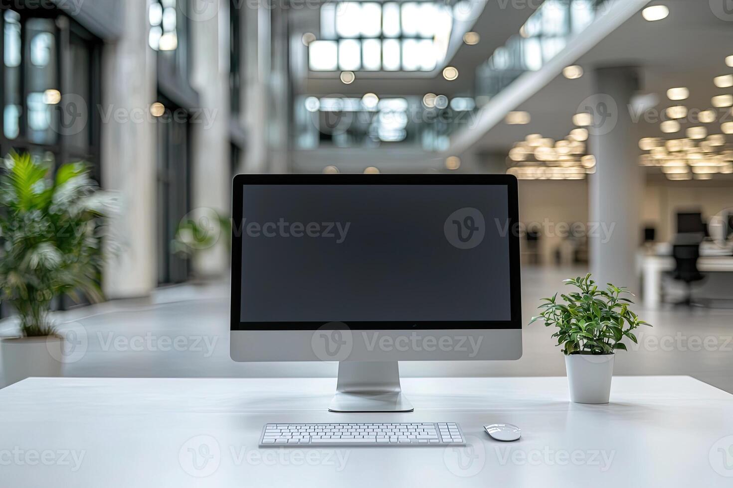 Minimalist white desk with a computer and office background, blurred business center interior in the blurred background. Mockup for design or presentation photo