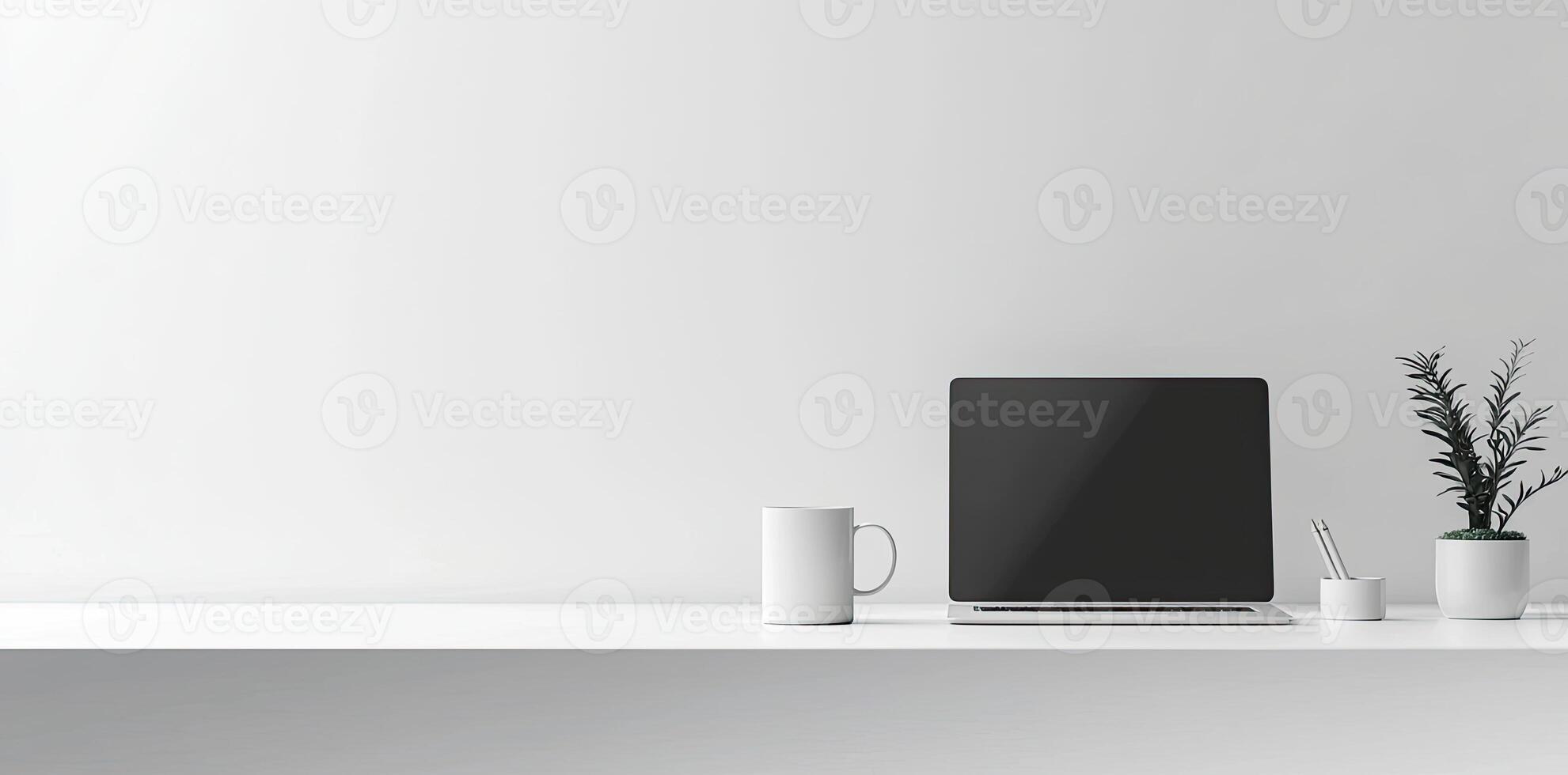Minimalist white office desk with laptop and coffee mug on a blurred background, with space for text, representing the concept of working from home photo