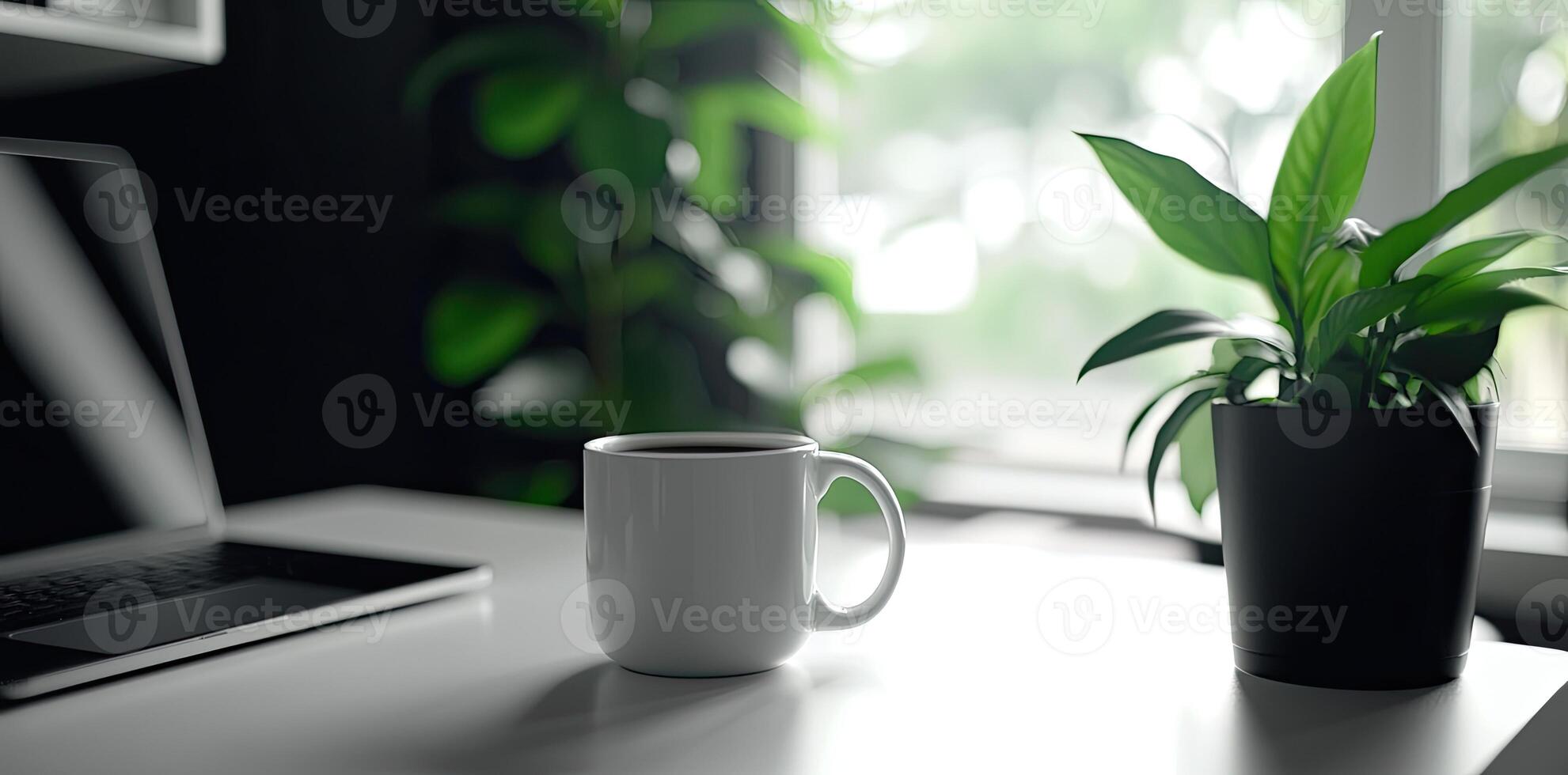 Minimalist white office desk with laptop and coffee mug on a blurred background, with space for text, representing the concept of working from home photo