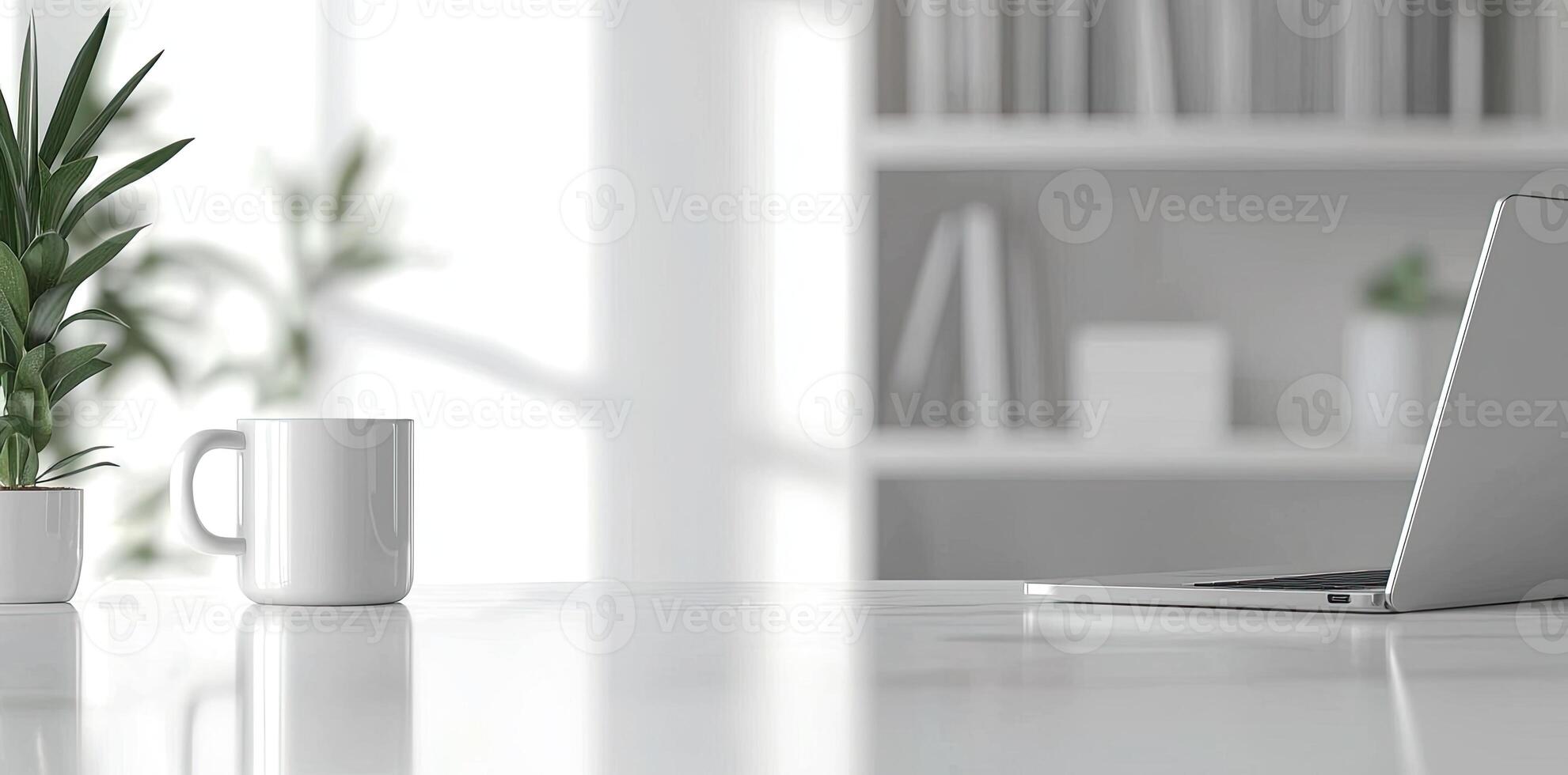 Minimalist white office desk with laptop and coffee mug on a blurred background, with space for text, representing the concept of working from home photo