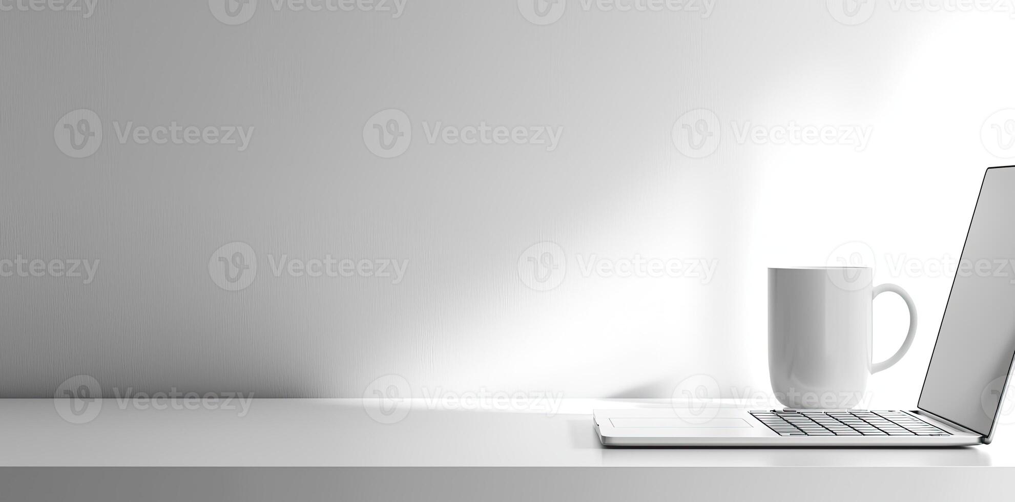 Minimalist white office desk with laptop and coffee mug on a blurred background, with space for text, representing the concept of working from home photo