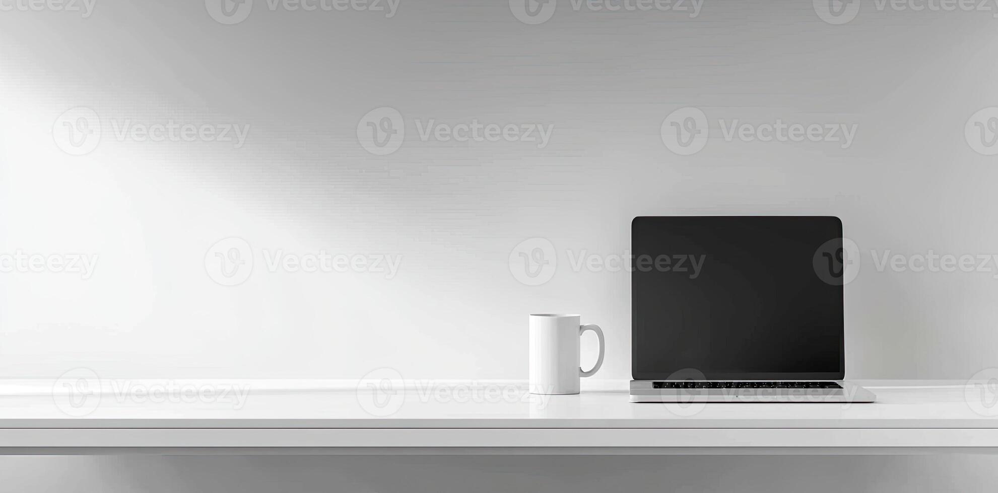 Minimalist white office desk with laptop and coffee mug on a blurred background, with space for text, representing the concept of working from home photo