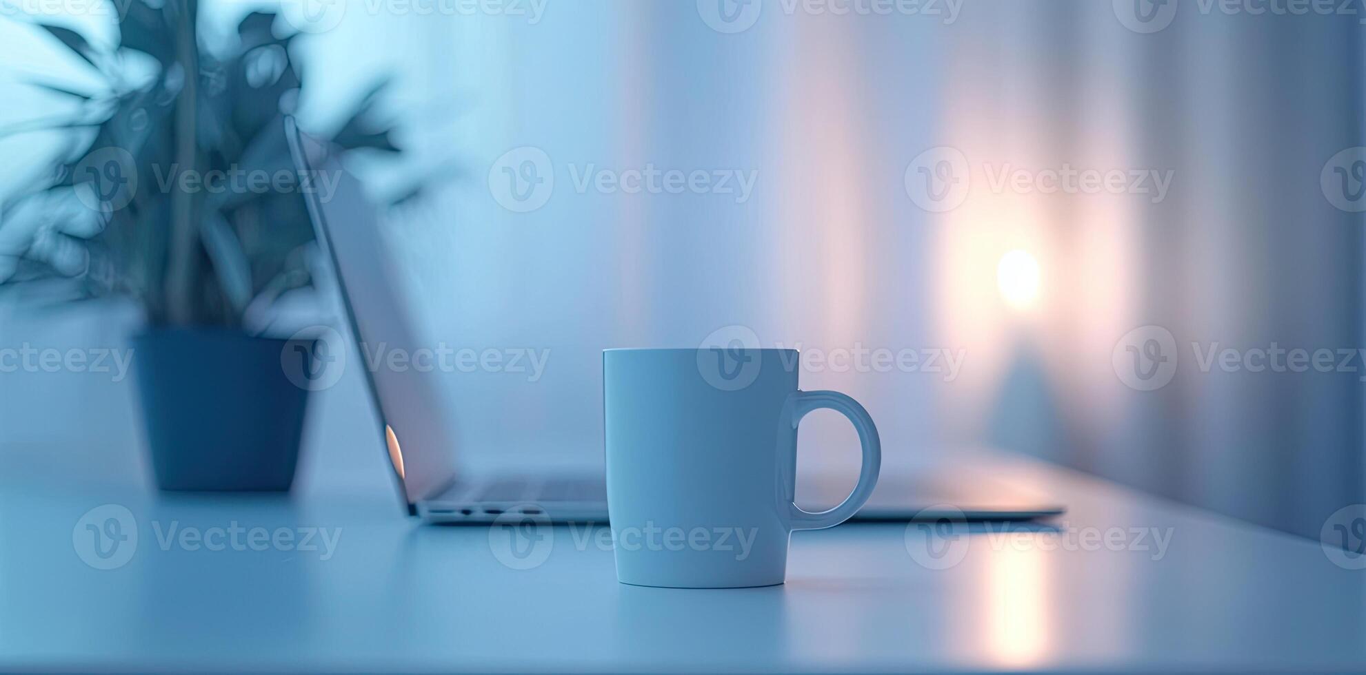 Minimalist white office desk with laptop and coffee mug on a blurred background, with space for text, representing the concept of working from home photo