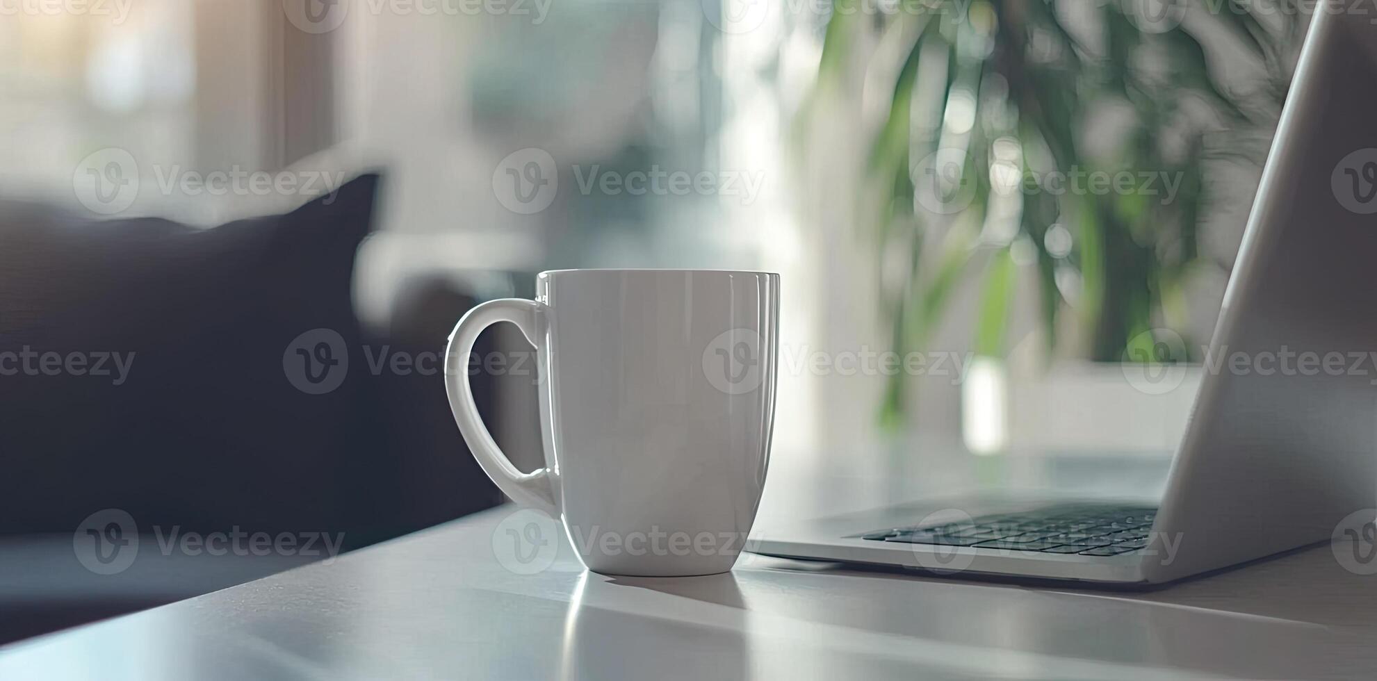 Minimalist white office desk with laptop and coffee mug on a blurred background, with space for text, representing the concept of working from home photo