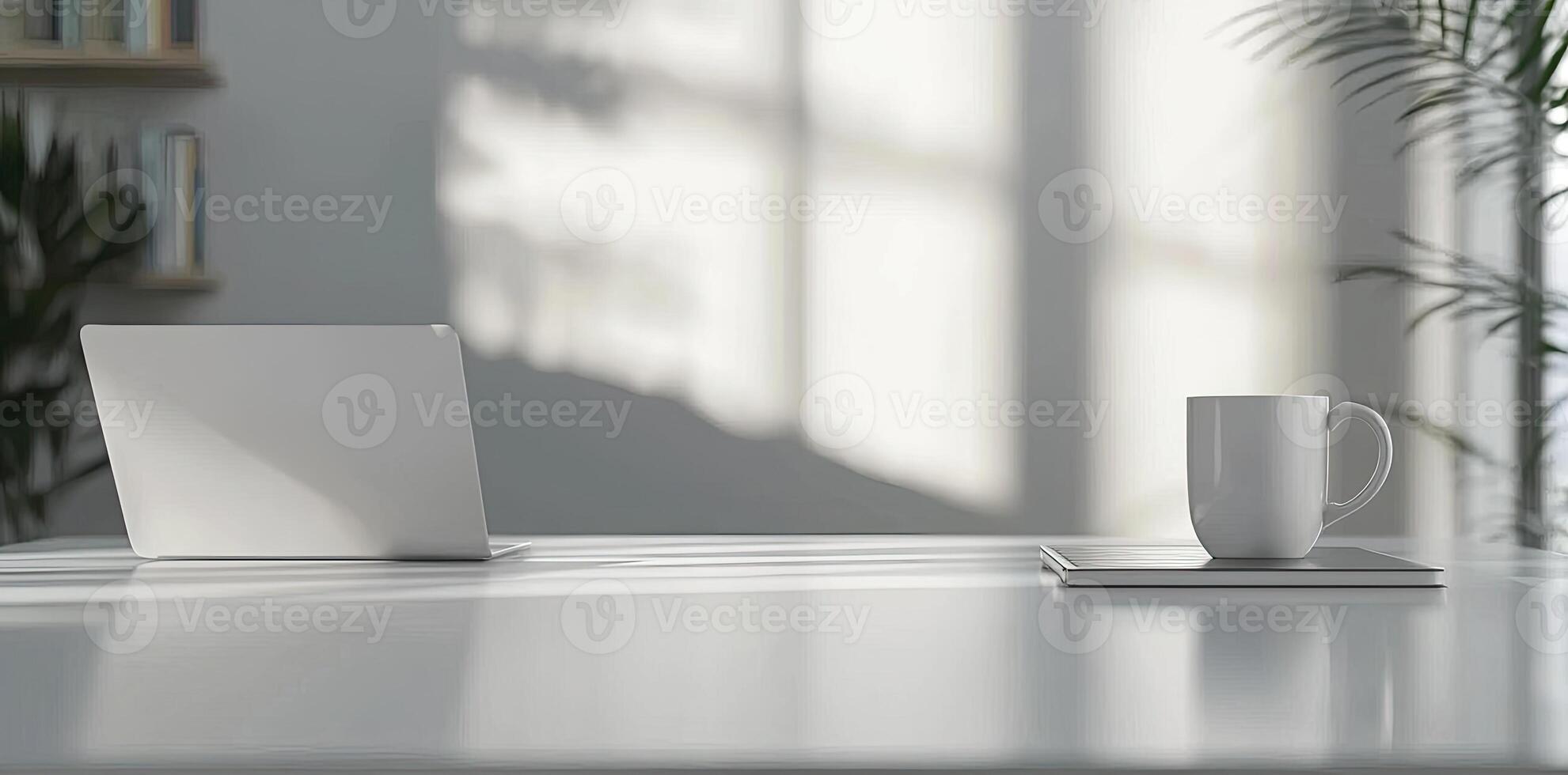 Minimalist white office desk with laptop and coffee mug on a blurred background, with space for text, representing the concept of working from home photo