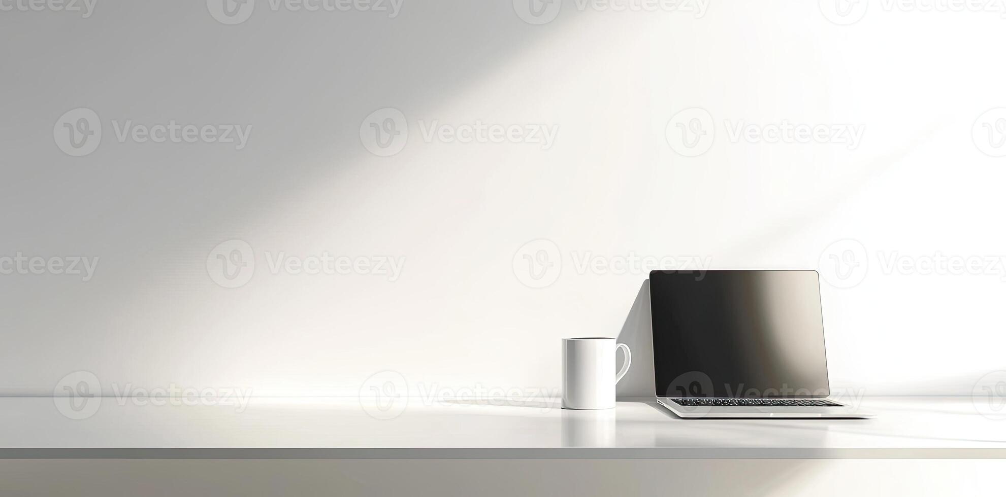 Minimalist white office desk with laptop and coffee mug on a blurred background, with space for text, representing the concept of working from home photo