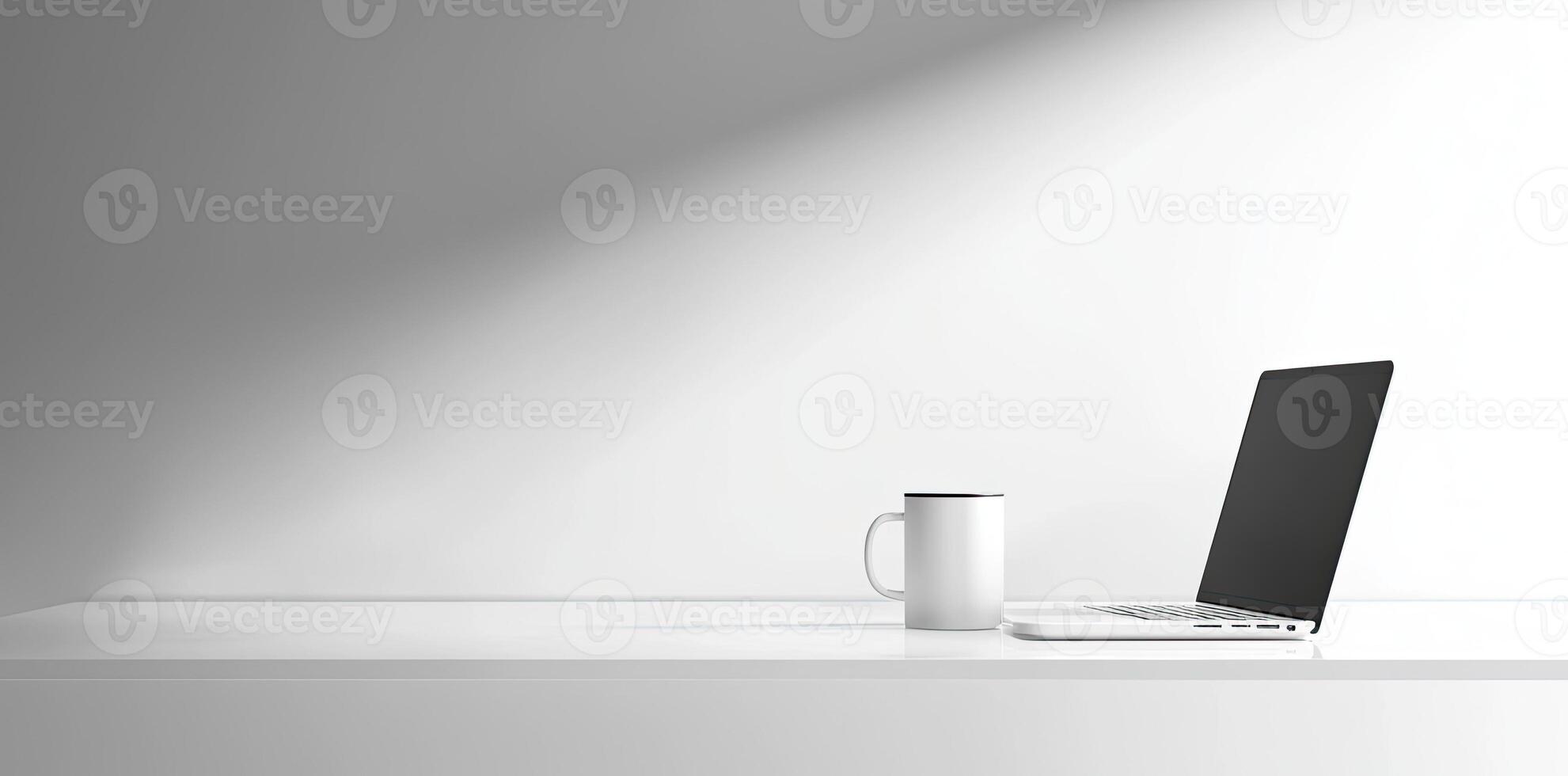 Minimalist white office desk with laptop and coffee mug on a blurred background, with space for text, representing the concept of working from home photo