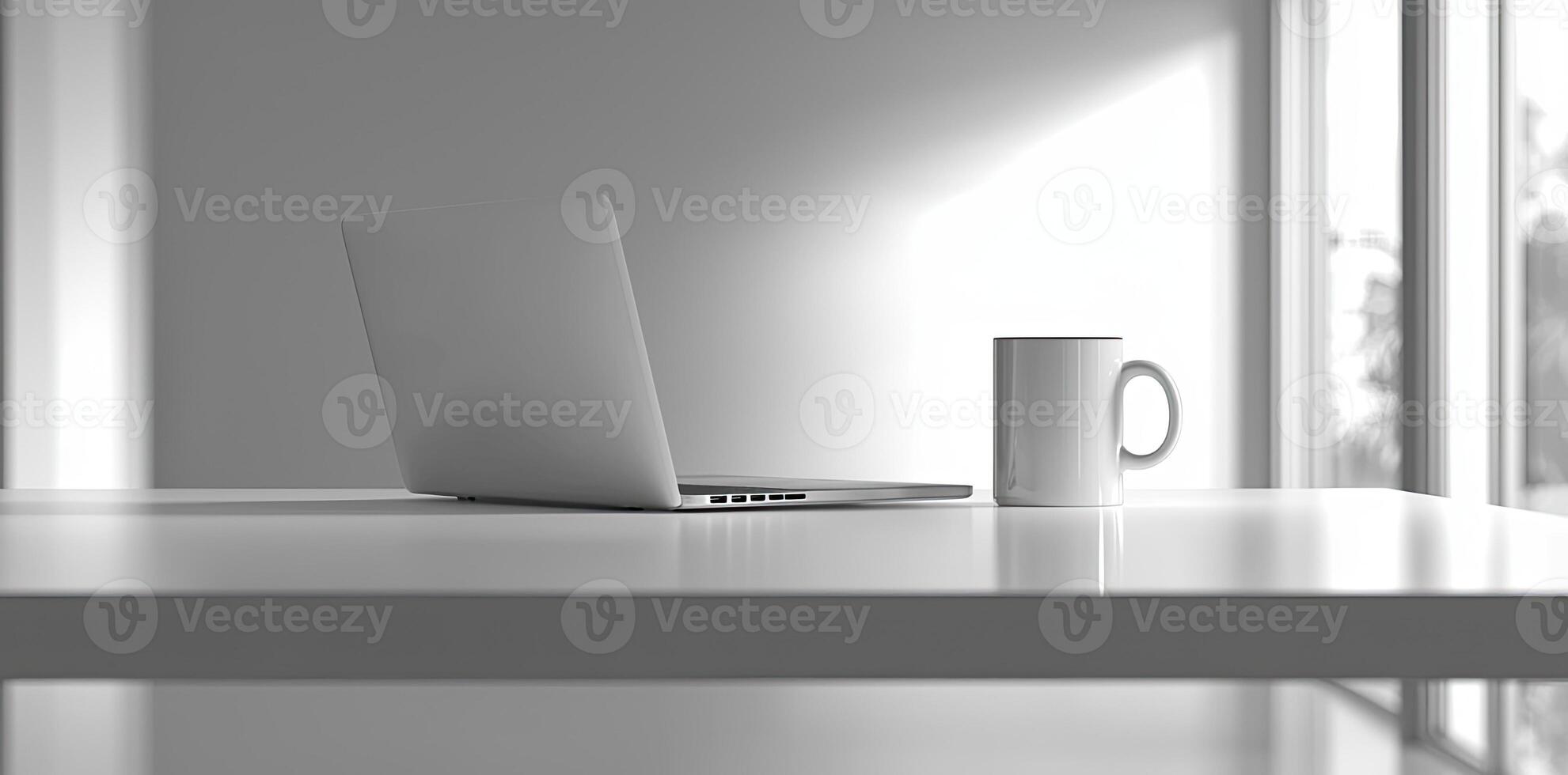 Minimalist white office desk with laptop and coffee mug on a blurred background, with space for text, representing the concept of working from home photo