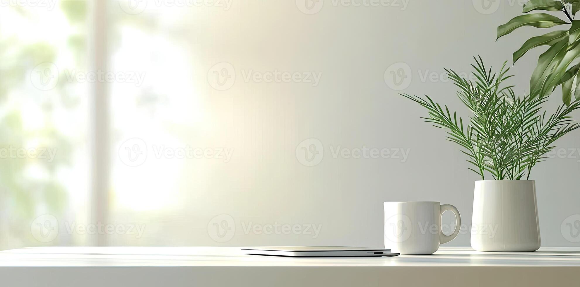 Minimalist white office desk with laptop and coffee mug on a blurred background, with space for text, representing the concept of working from home photo