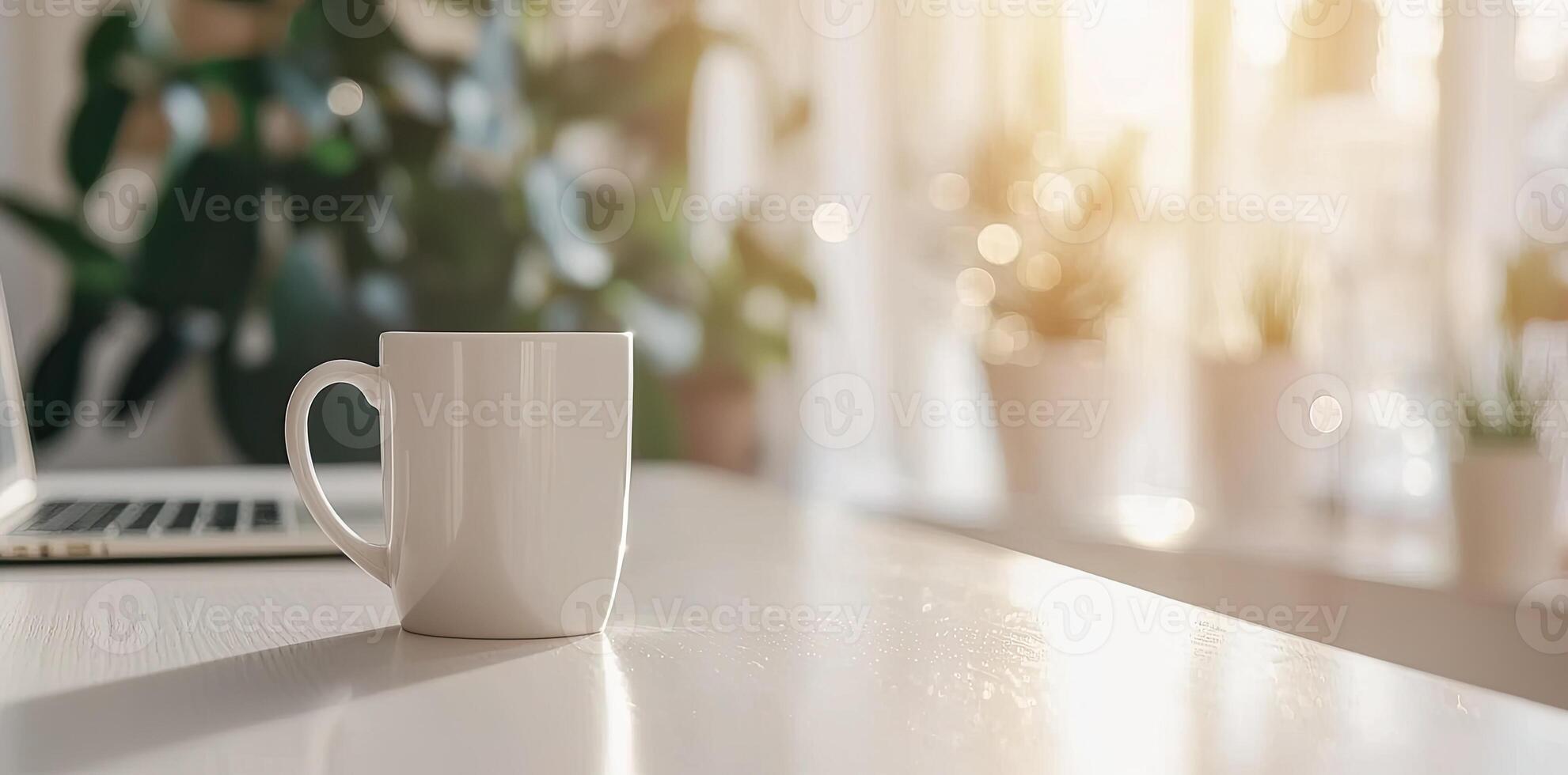 Minimalist white office desk with laptop and coffee mug on a blurred background, with space for text, representing the concept of working from home photo