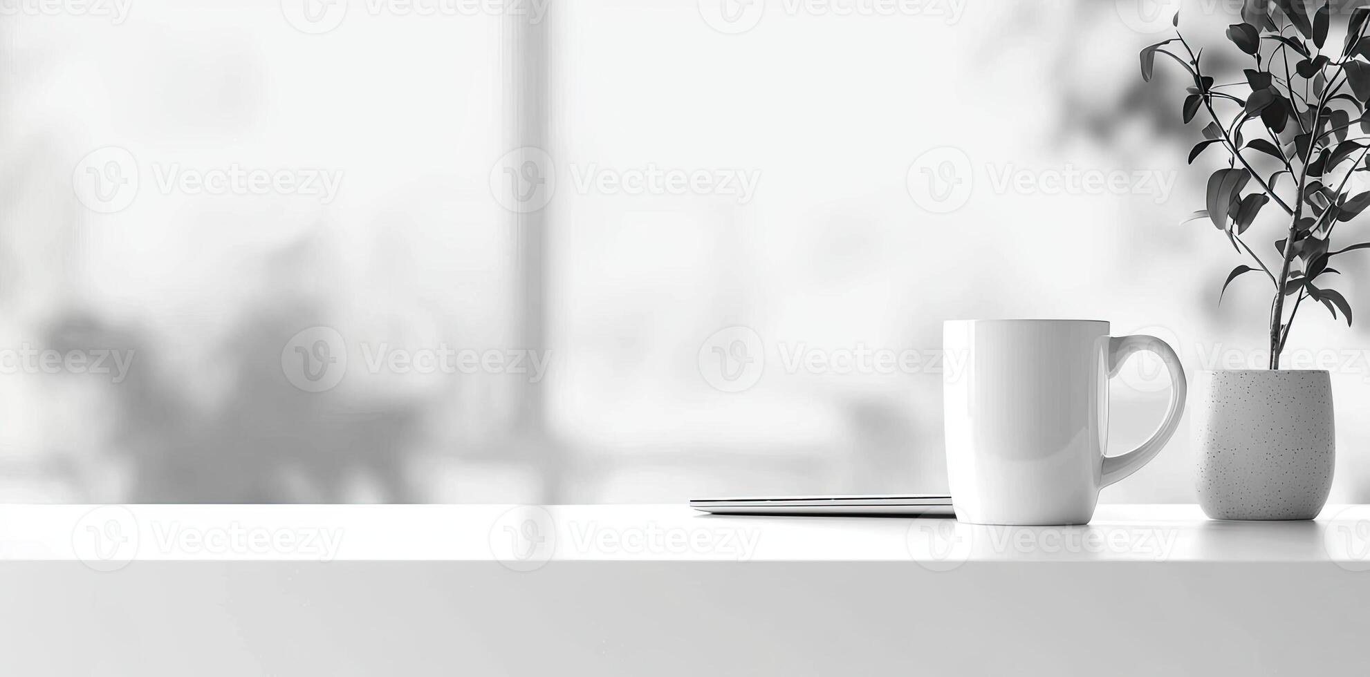 Minimalist white office desk with laptop and coffee mug on a blurred background, with space for text, representing the concept of working from home photo