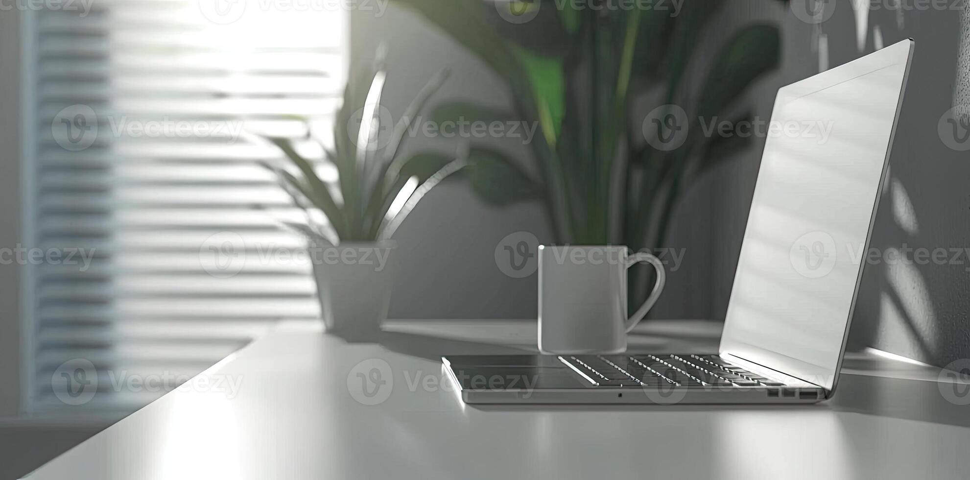 Minimalist white office desk with laptop and coffee mug on a blurred background, with space for text, representing the concept of working from home photo
