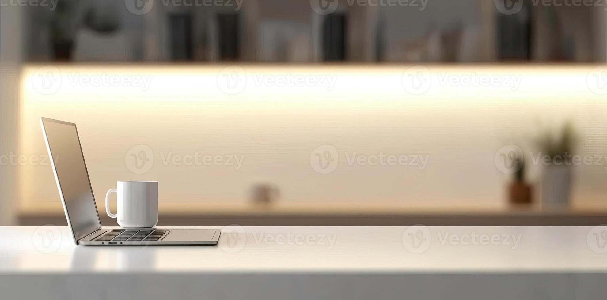 Minimalist white office desk with laptop and coffee mug on a blurred background, with space for text, representing the concept of working from home photo