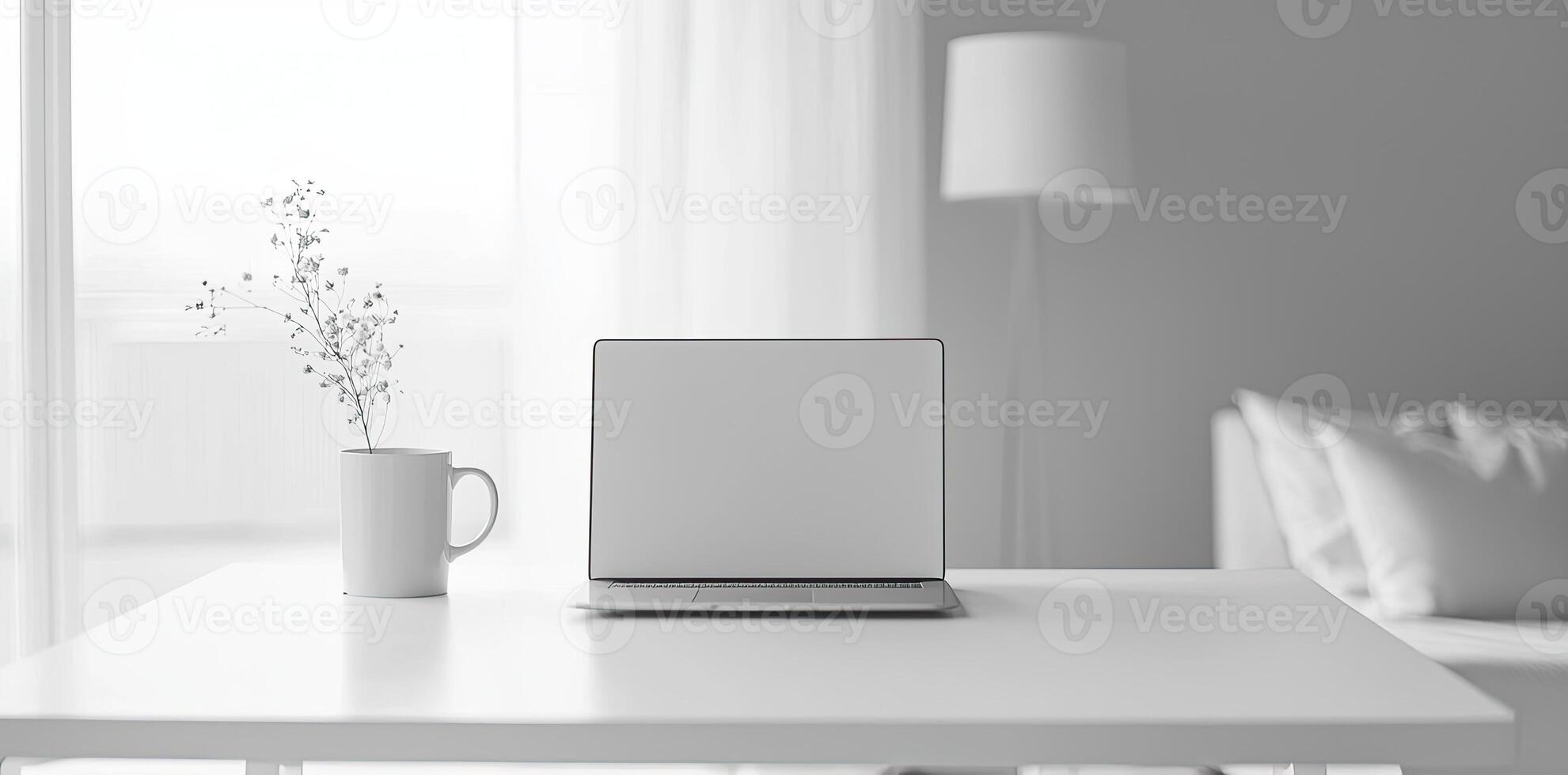 Minimalist white office desk with laptop and coffee mug on a blurred background, with space for text, representing the concept of working from home photo