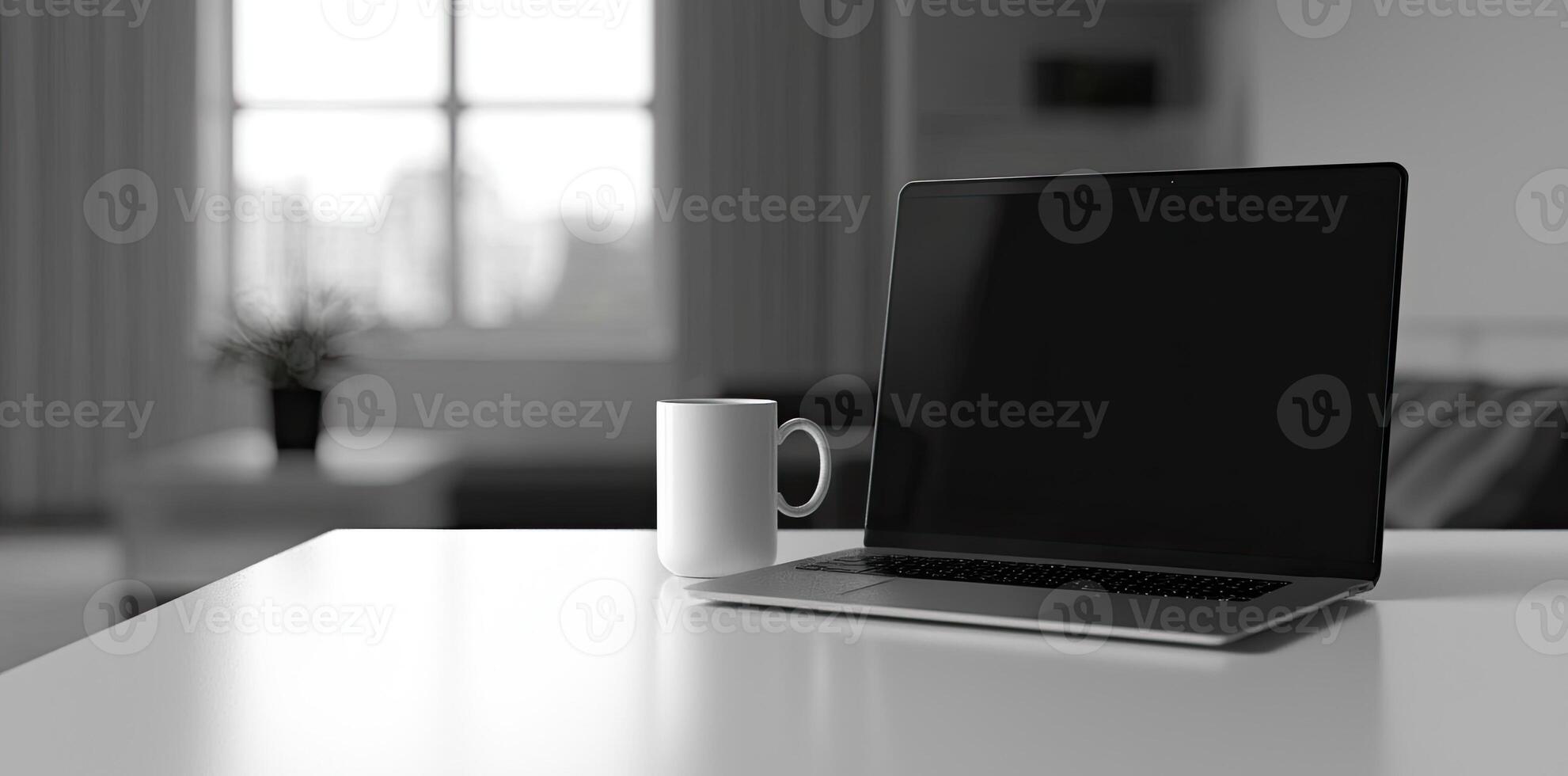 Minimalist white office desk with laptop and coffee mug on a blurred background, with space for text, representing the concept of working from home photo