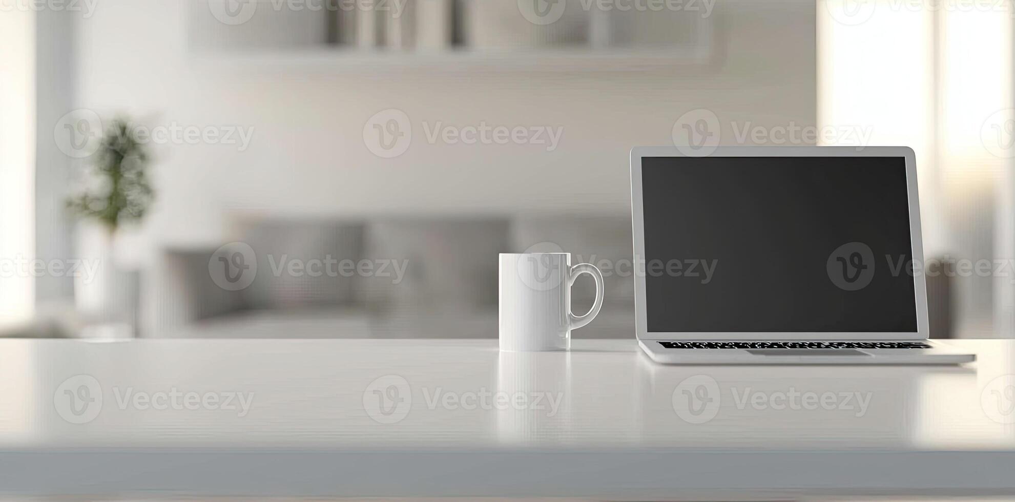 Minimalist white office desk with laptop and coffee mug on a blurred background, with space for text, representing the concept of working from home photo