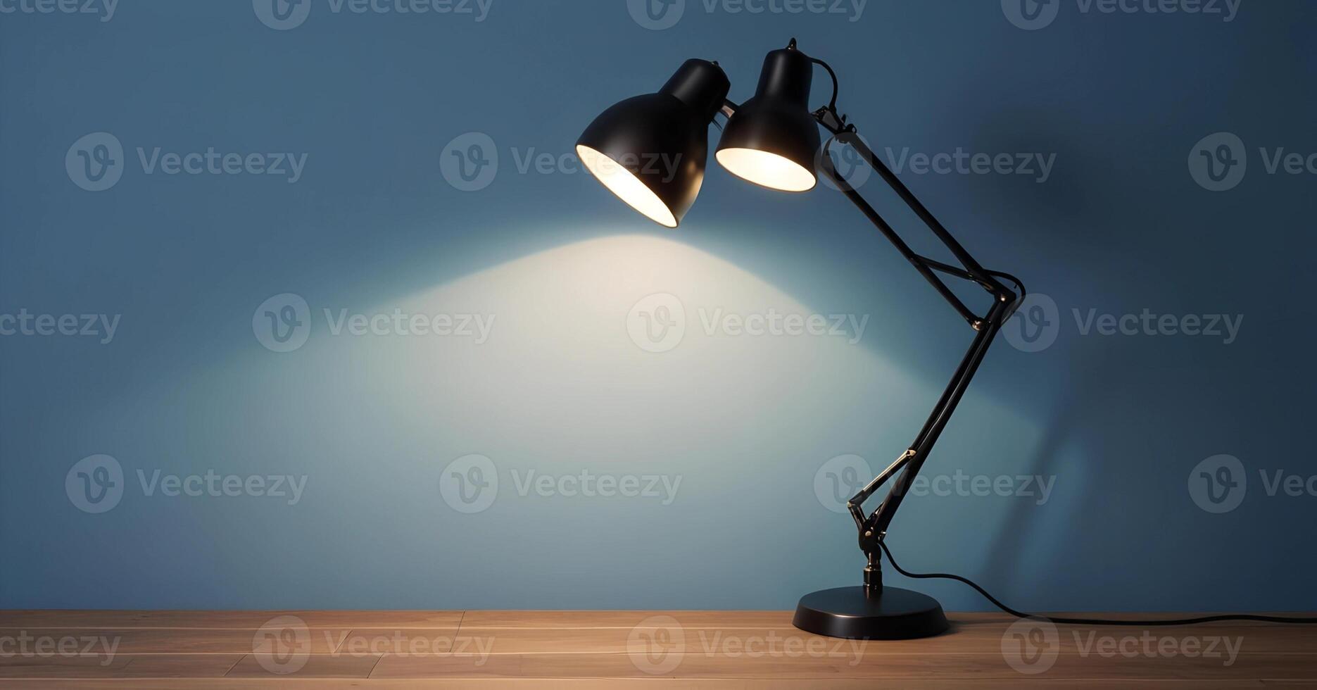 A lamp on a table in front of a blue wall photo