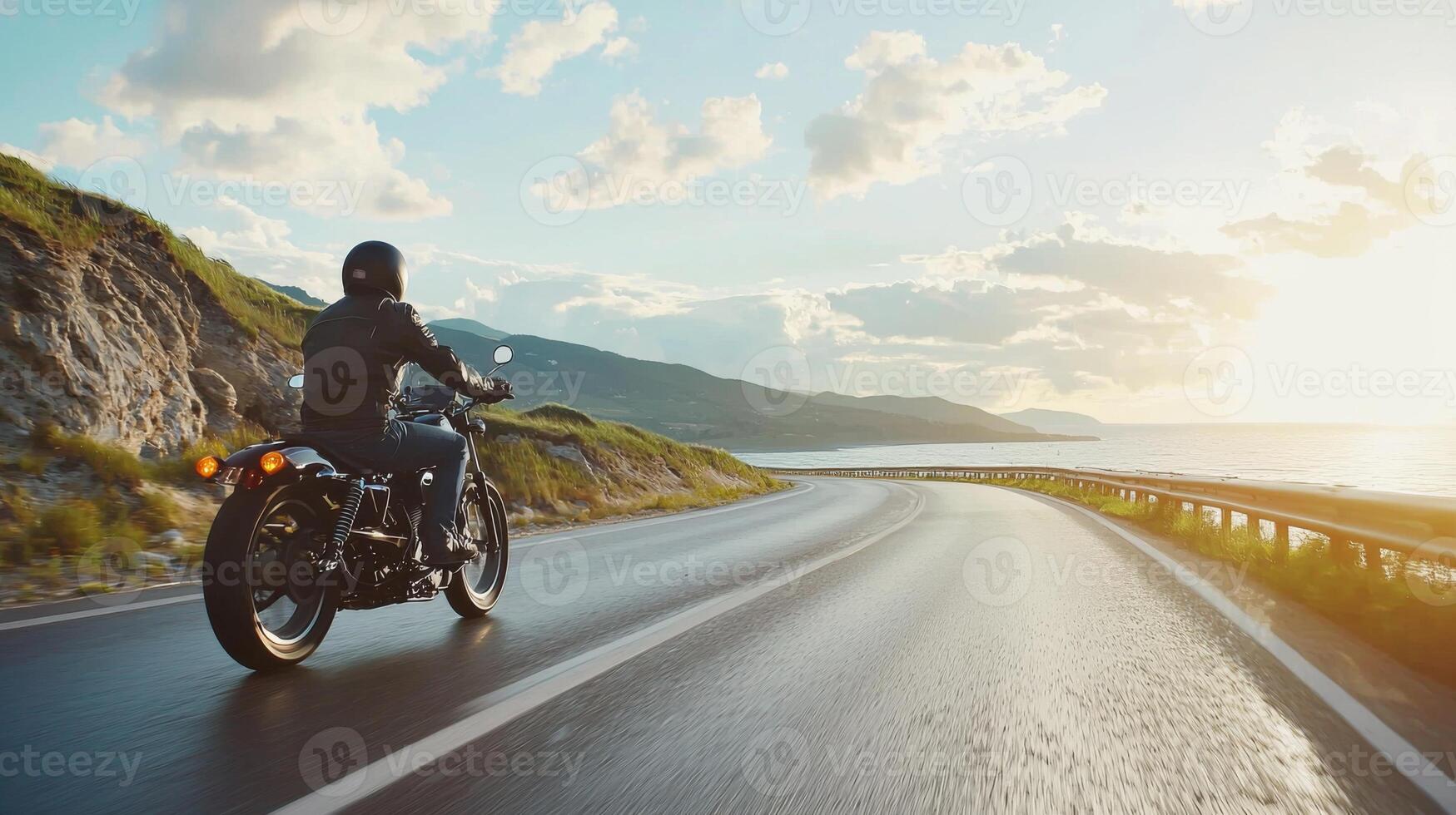 Motorcyclist cruising along coastal highway. A biker enjoying a solitary ride on a coastal road photo