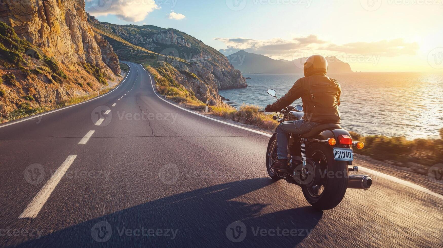 Motorcyclist cruising along coastal highway. A biker enjoying a solitary ride on a coastal road photo