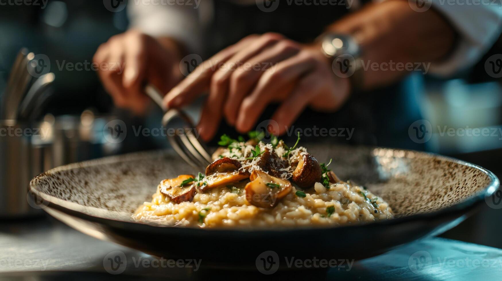 The chef prepares Risotto with mushrooms. Risotto with mushrooms is served in an elegant plate photo