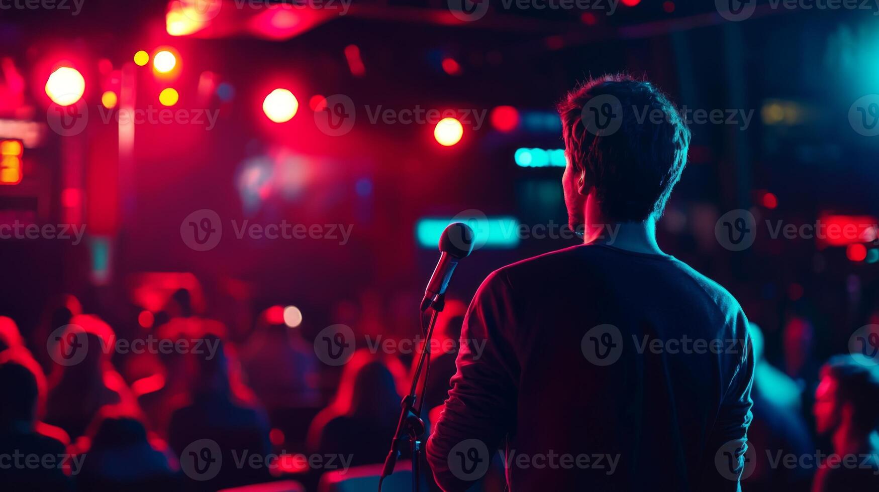 Comedian performing stand-up show on stage routine in comedy club photo