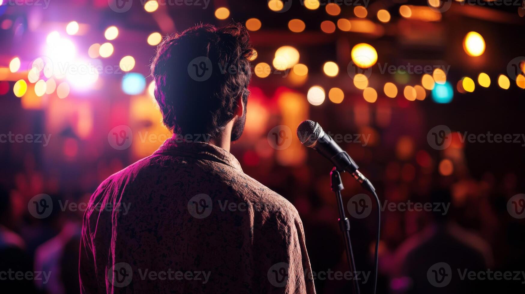 Comedian performing stand-up show on stage routine in comedy club photo