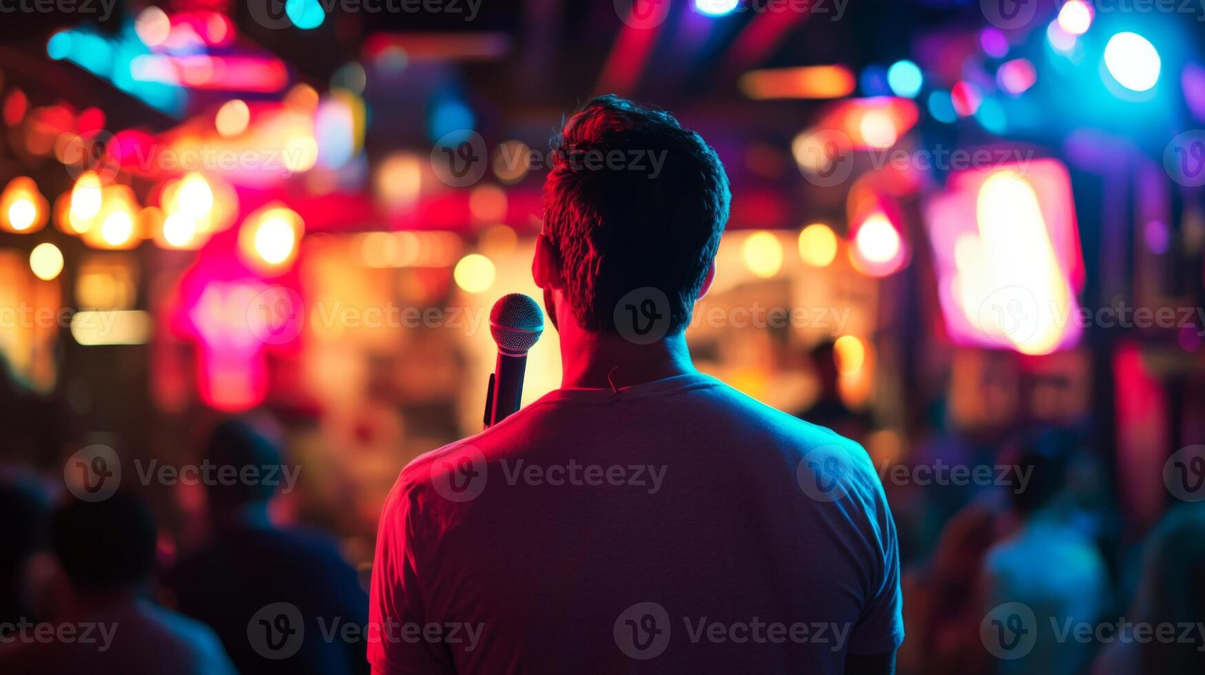 Comedian performing stand-up show on stage routine in comedy club photo