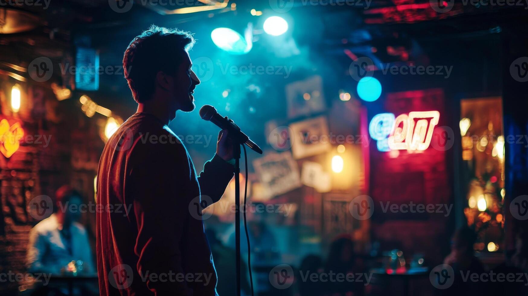 Comedian performing stand-up show on stage routine in comedy club photo