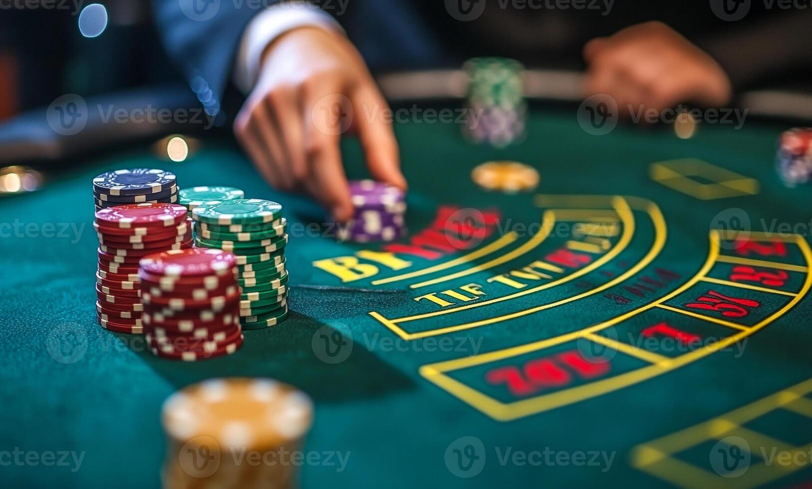A man is playing a game of poker with chips on a green table. The chips are numbered from 1 to 52 photo