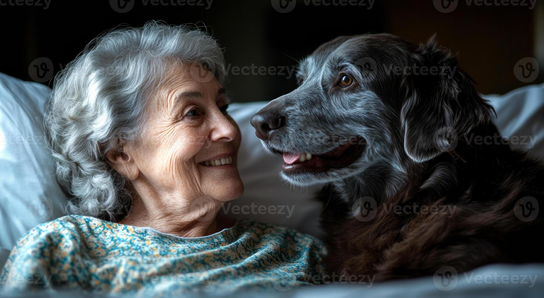A woman and a dog are laying on a bed together. The woman is smiling and the dog is wagging its tail. Scene is happy and relaxed photo