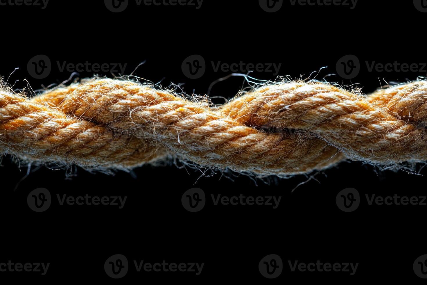 A rope is twisted and knotted. The rope is brown and has a lot of knots photo
