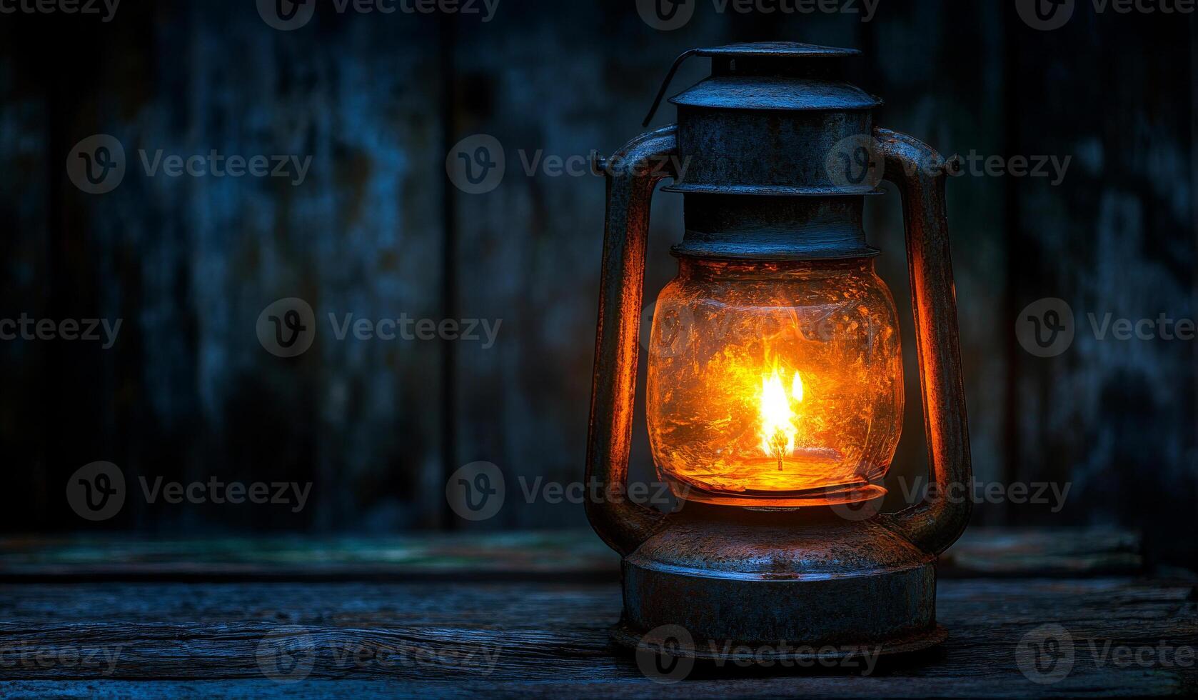 A lantern with a candle inside is lit up in a dark room. The warm glow of the candle creates a cozy and inviting atmosphere. The lantern is placed on a wooden surface photo