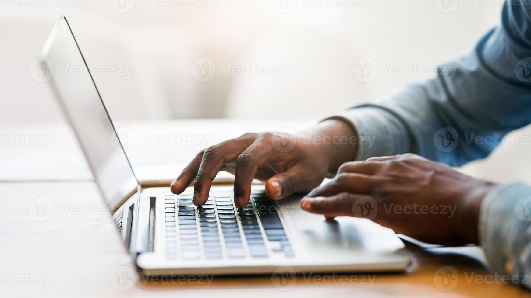 Hands of unrecognizable african american businessman typing on laptop keyboard in office, closeup with copy space, panorama photo